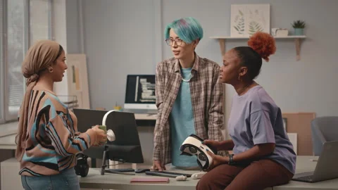 Multiethnic Team of IT Specialists Chatting at Workplace Stock Footage 241273288