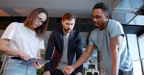 Multiethnic team of IT startup having conversation in coworking space, working Stock Footage 180071170