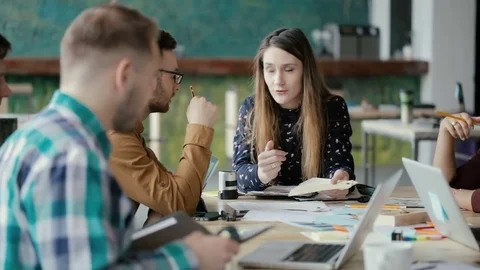 Multiethnic team meeting in modern start-up office. Group of young people Stock Footage