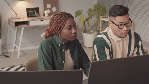 Multiethnic Team of Programmers Discussing Software at Workplace Video stock 195980604