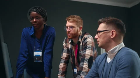 Multiethnic team of software designers or data analysts solving problem and Stock Footage 233741363