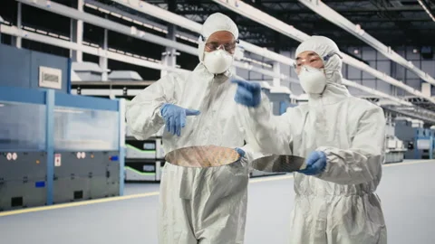 Multiethnic team of specialists holding processed silicon wafer Stock Footage 333395487