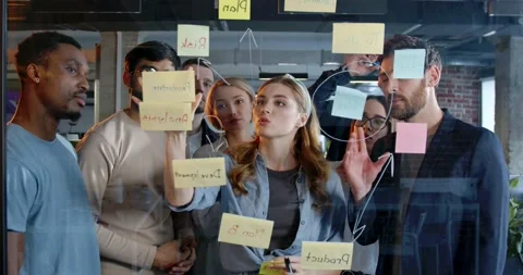 Multiethnic team of startup planning future tasks and to-do list in office. Men Video stock 180038176