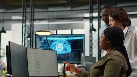 Multiethnic technicians in startup office work with artificial intelligence Stock Footage 323405319