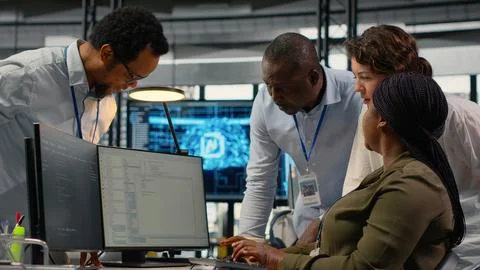 Multiethnic technicians in startup office work with artificial intelligence 스톡 사진