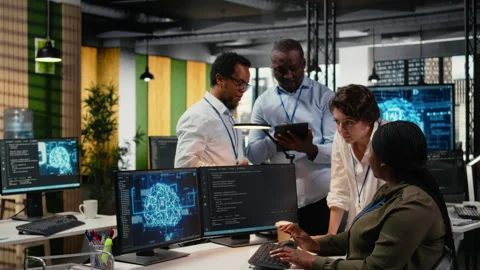 Multiethnic technicians use devices in AI startup to train predictive models Stock Footage 323034799