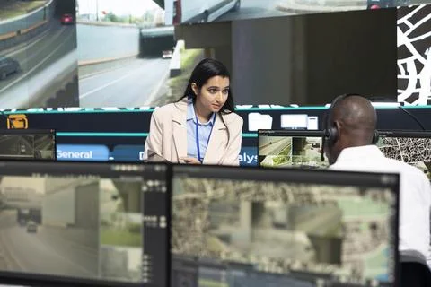 Multiethnic traffic operators working together, monitoring urban transport flow Stock Photos