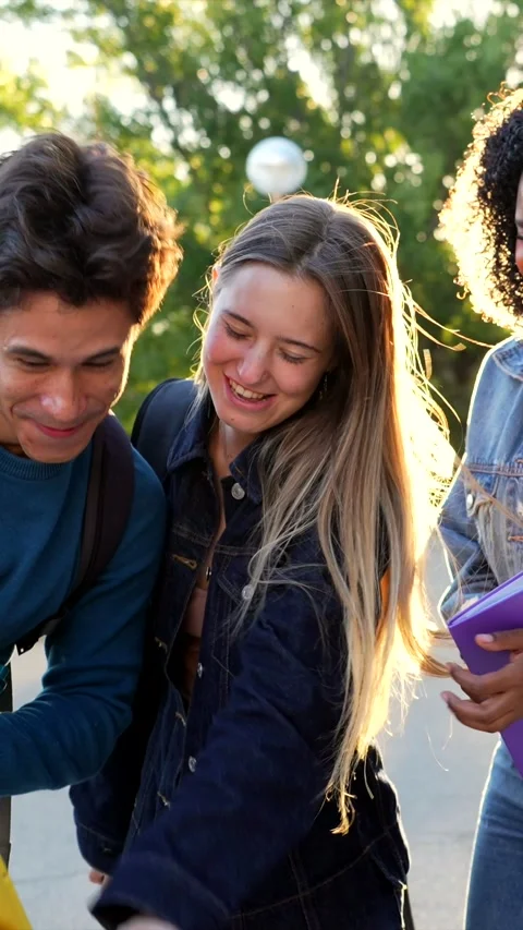 Multiethnic university students socializing with smartphone on campus Stock Footage 317849967