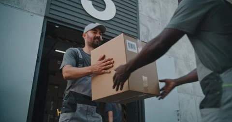 Multiethnic Workers Loading Cardboard Boxes Outside of Logistics Distribution Vídeo Stock 312272375