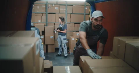 Multiethnic Workers Loading Cardboard Boxes in Delivery Truck from Logistics Stock Footage 312295602