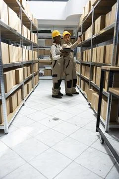 Multiethnic workers team tracking inventory using bar code systems Stock-Fotos