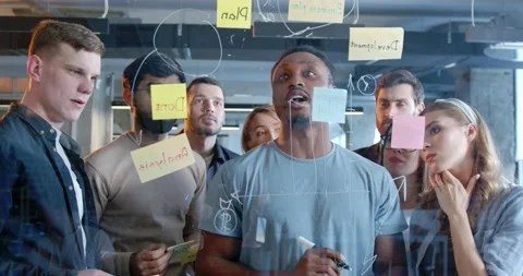 Multiethnic working team making plans for company future and sticking to-do Stock Footage 180047376