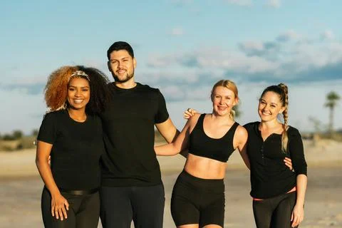 Multiethnic yoga class group standing facing the camera outdoors Stock Photos