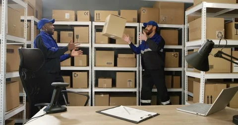 Multiethnic young cheerful postmen in uniform working at postal office and Stock Footage 125204815