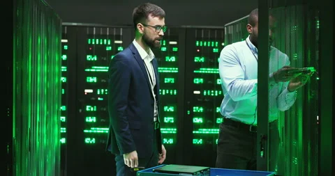 Multiethnic young men engineers with taking out hardware from server and talking Stock Footage 137550914