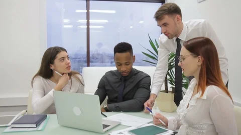 Multiethnical group of financial analytics is discussing the bitcoin exchange Stock Footage 85554992