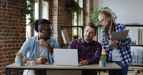 Multiethnical two men and Caucasian woman working together over business project Stock Footage 101001538