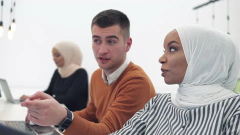 Multiethnics team software developers discuss the project in modern startu of Stock Footage 224808488