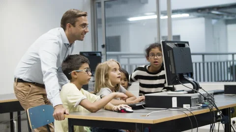 Multietnic children doing task during computer science lesson. Stock Footage 153832168