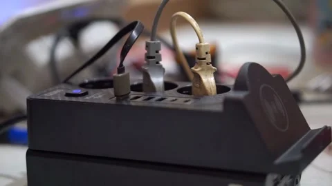 Multifunction charging station with USB cables and wireless charging feature Stock Footage 335527328