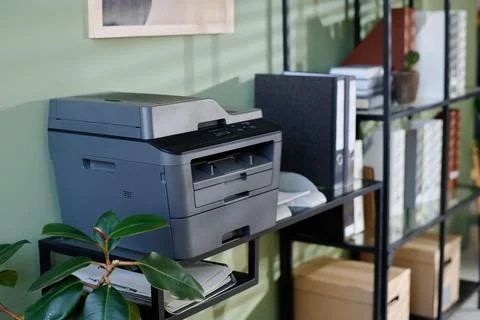 Multifunction Printer on Office Shelf with Green Plant Stock Photos