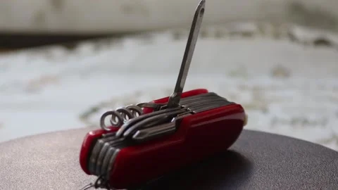 Multifunctional red pocket knife rotates 360 degrees, 4k Stock Footage 248615487