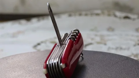 Multifunctional red pocket knife rotates 360 degrees, 4k Stock Footage 248615488