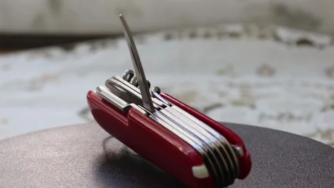 Multifunctional red pocket knife rotates 360 degrees, 4k Stock Footage 248615581