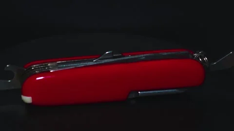 Multifunctional red pocket knife rotates 360 degrees, 4k Stock Footage 248619489