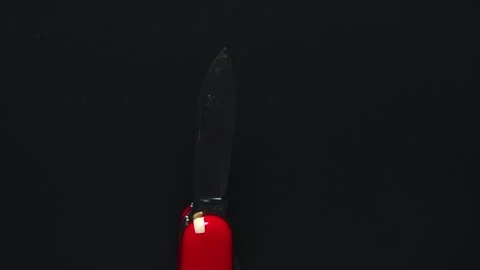 Multifunctional red pocket knife rotates 360 degrees, 4k Stock Footage 248619670