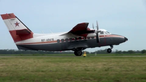 Multifunctional Turbolet L-410 accelerates along the runway and takes off. Stock Footage 121203718