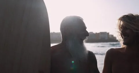 Multigeneration family having fun while surfing on the beach Stock Footage 151685372