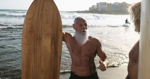 Multigeneration friends having fun while surfing on beach Stock Footage 151685755