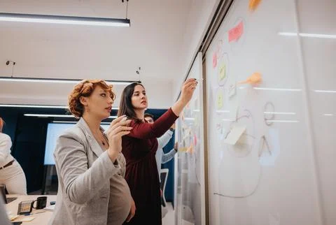 Multigenerational team analyzing statistics and brainstorming for profit growth. Stock Photos