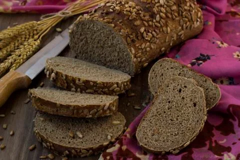Multigrain gluten-free bread sliced on wooden table Stock Photos