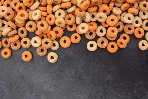Multigrain hoops breakfast cereal border on dark grey slate Stock Photos