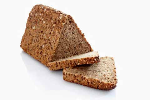 Multigrain rye bread loaf with slice on white background, close up Stock Photos