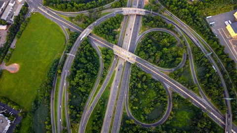 Multilane highway interchange surrounded by forest, United States Stock Footage 343851356