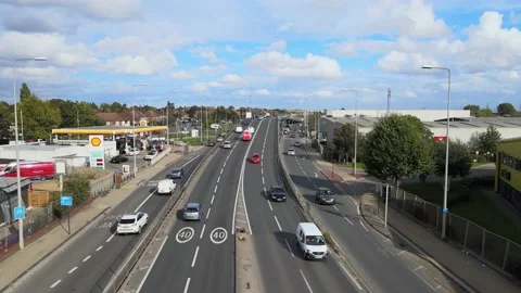 Multilane multilevel road in suburb, vehicles driving around gas station Stock Footage 164684525