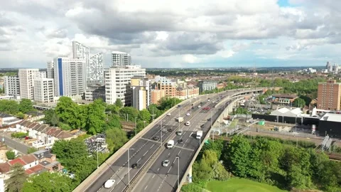 Multilane road with heavy traffic leading on bridge over railway tracks Stock Footage 156701212