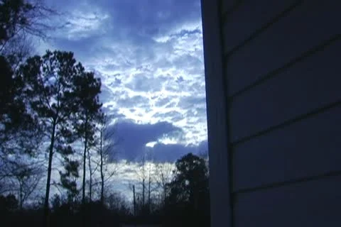 Multilayer clouds time lapse from side of a house Stock Footage 10757479