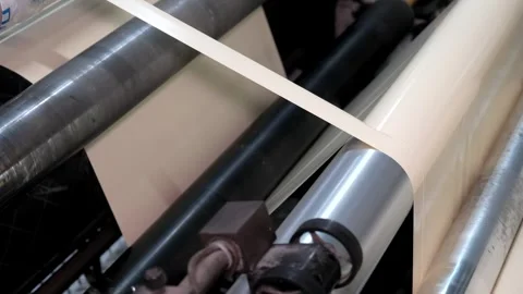 Multilayer plastic film rolling on the machine at the factory. Goods and pr.. Stock Footage 306144298