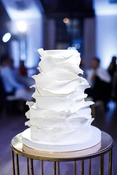 Multilevel wedding cake on a metal table Stock Photos