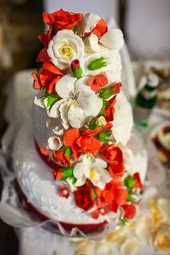 Multilevel wedding cake on the table decorated with roses Stock Photos