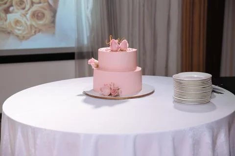 Multilevel wedding cake on white table. Sweets in white and pink colour Stock Photos