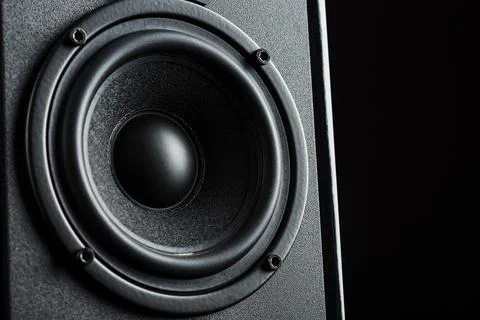 Multimedia speaker system speaker close-up on a black background. Stock Photos