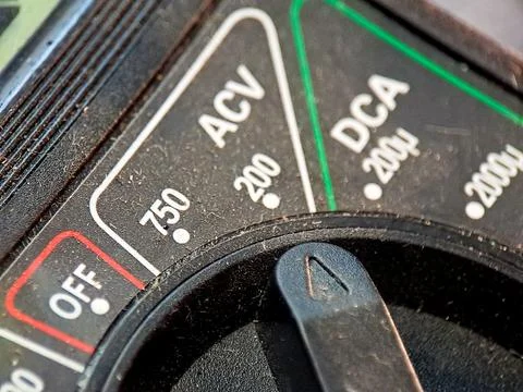 A multimeter dial displaying ACV, DCA, and OFF settings shows electrical me.. Stock Photos