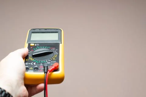 Multimeter in a man's hand Stock Photos