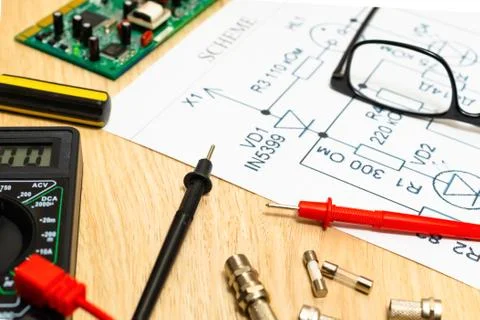 Multimeter probes examining a computer circuit board and circuit. Stock Photos