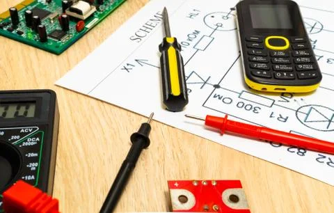 Multimeter probes examining a computer circuit board and circuit. Stock Photos